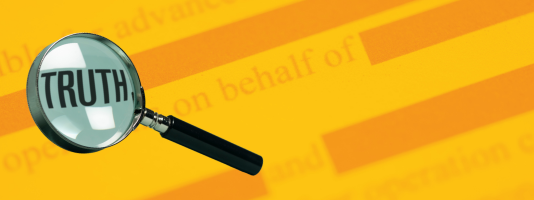 Magnifying glass over redacted text with the word, "truth" in the magnifying glass.